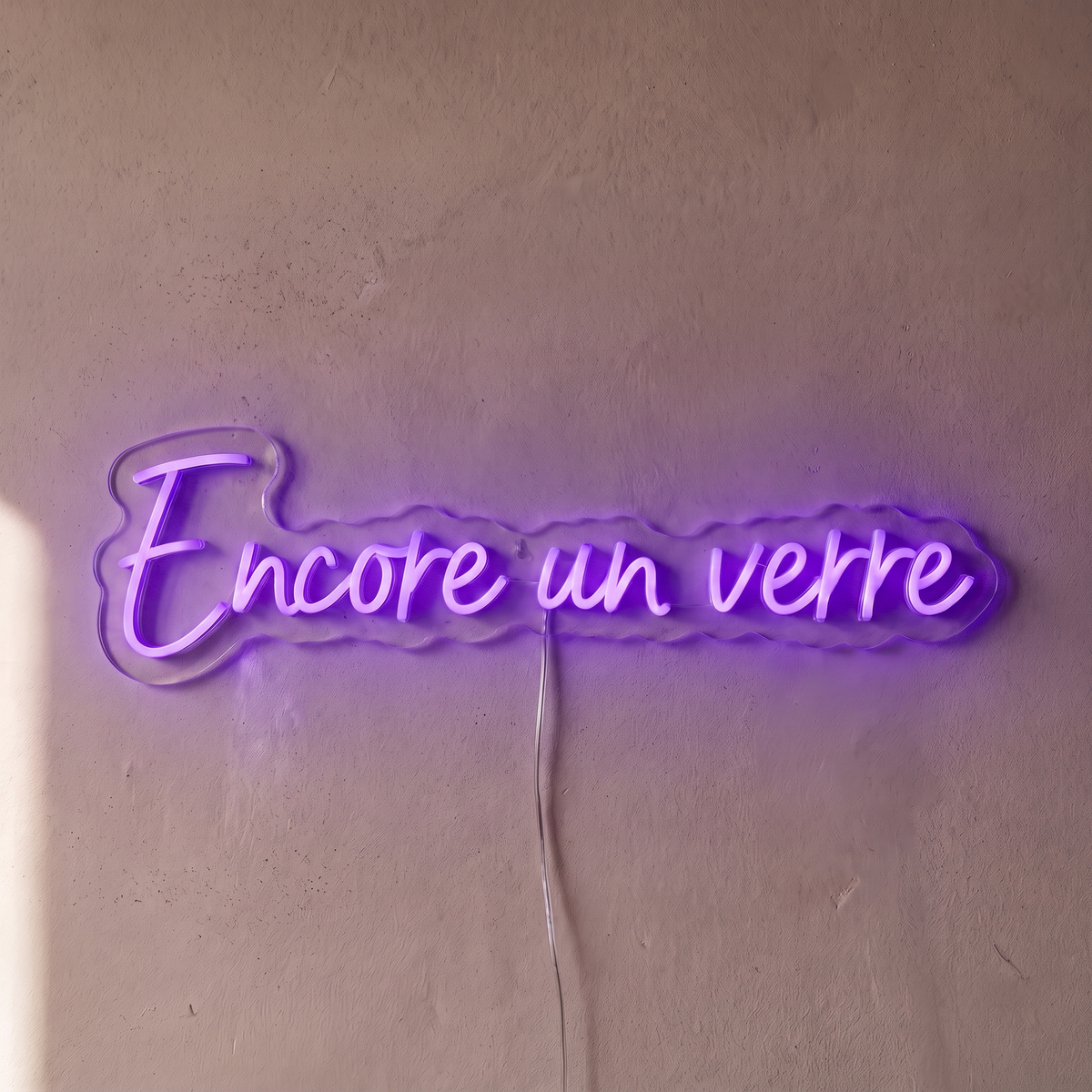 Néon mural « Encore un verre » violet, gros plan sur fond beige