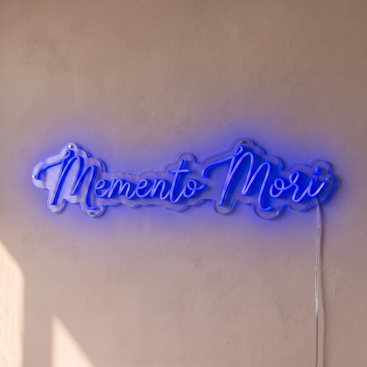 Néon mural « Memento Mori » bleu, gros plan sur fond beige
