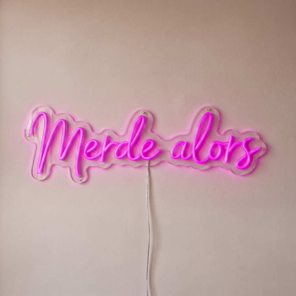 Néon mural « Merde alors » rose, gros plan sur fond beige