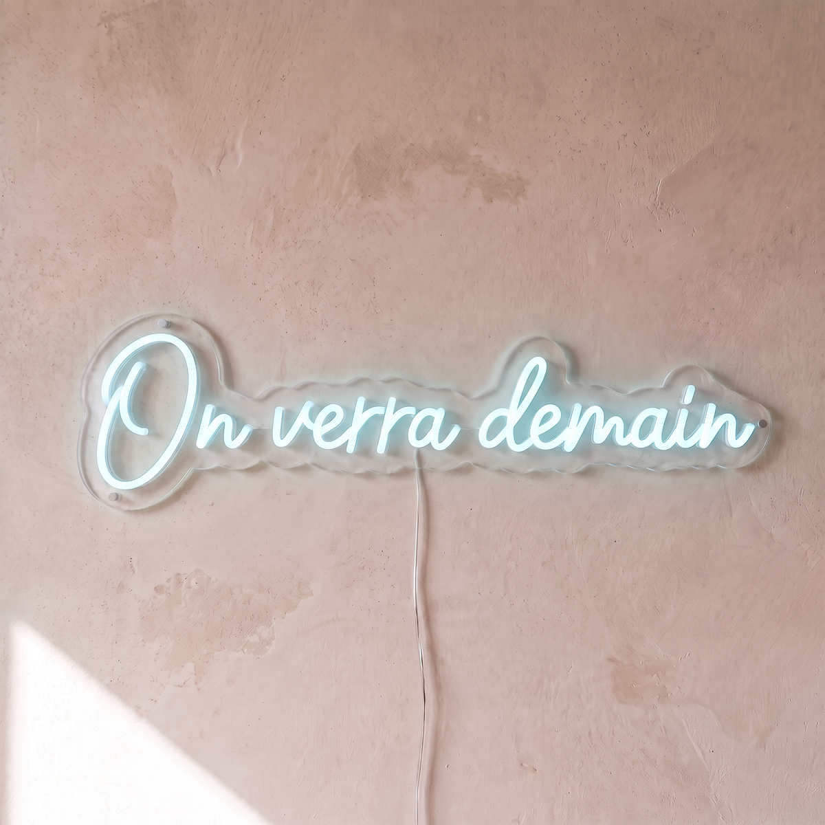 Néon mural « On verra demain » blanc froid, gros plan sur fond beige