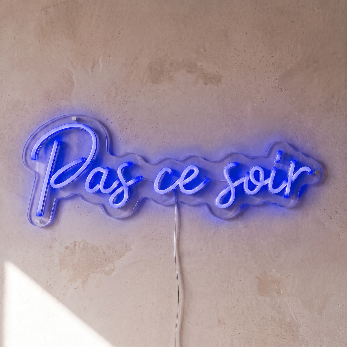 Néon mural « Pas ce soir » bleu, gros plan sur fond beige