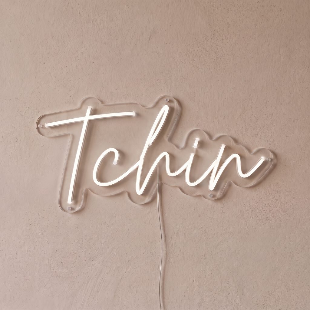 Néon mural « Tchin » blanc, gros plan sur fond beige